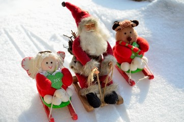 Christmas toys Santa Claus, angel, bear, in a sleigh, in a snowy forest, outdoors.