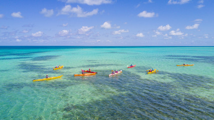 Wall Mural - Aerial view of tropical island at Glover's Reef Atoll in Belize with a group of kayakers