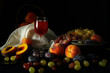 Still life with fruit and a glass of wine on a dark background