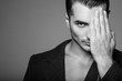 © alesgon - Intense black&white portrait of handsome young man with stylish haircut posing over gray background. Perfect hair & skin. Close up. Studio shot
