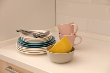 Wall Mural - Clean dishware and cutlery on counter in kitchen