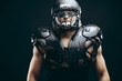 © alfa27 - Portrait of athlete - american football player wearing protective shields on bare chest, looking confidently, prepare to tear to pieces everybody who to gets in the way. Team captain.