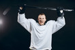 © alfa27 - Portrait of cheerful handsome hockey player getting into the mood for winning before game starts. Sportsman in white uniform celebrating the victory. Sport, Achievements and People concept