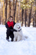 © Alexander - Beautiful young girl with a Samoyed dog in the winter forest on the snow