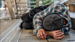 poor homeless beggar sleeping on pathway floor in suffering of unemployment asking for help