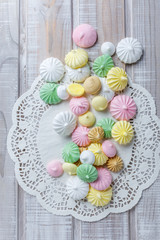 Wall Mural - Colorful meringue cookies on napkin, natural light selective focus