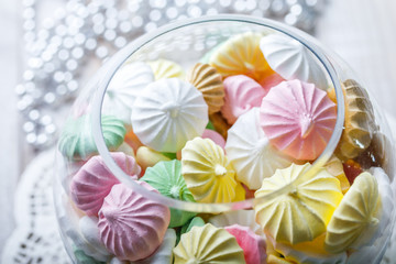 Wall Mural - Colorful meringue cookies on napkin, natural light selective focus