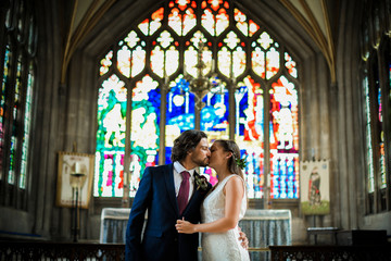 Wall Mural - Bride and groom kissing in the church