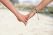 Love and friendships concept. Holding hands closeup, outdoor candid photo