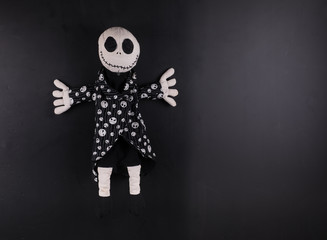 Wall Mural - creepy halloween doll on a black background