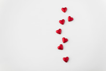 Valentines Day, Sweets And Confectionery Concept - Close Up Of Red Heart Shaped Chocolate Candies On White Background
