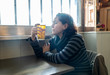 © SB Arts Media - Alcoholic depressed woman drinking in a bar feeling sad hopeless