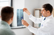 © Syda Productions - medicine, healthcare and people concept - doctor showing x-ray to patient at medical office in hospital
