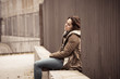 © SB Arts Media - Depressed young woman sitting on urban city street overwhelmed a