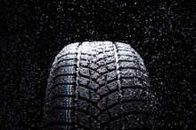 Winter Car Tires With Snow On Black Background