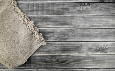 Wall Mural - cloth burlap on wooden table, wooden background