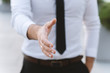 © speed300 - Man businessman in a white shirt and necktie gives a hand for a greeting.