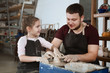 © ulza - Teacher man and child girl pupil in pottery