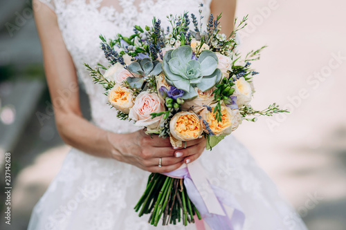 Bride Holding A Bouquet Of Flowers In A Rustic Style Wedding