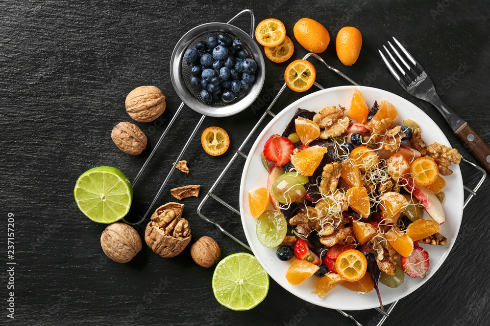 Delicious fresh salad with walnuts on plate