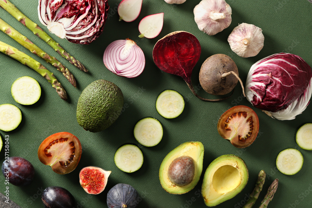 Various fresh vegetables with fruits on color background