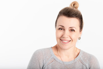 Wall Mural - Friendly smiling middle-aged woman isolated on grey background. Happy adult woman portrait