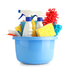 Basin with cleaning supplies on white background