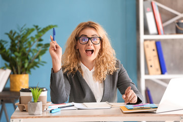 Beautiful young businesswoman having idea in office