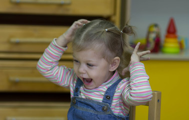 little girl playing and studying on lessons in kindergarden