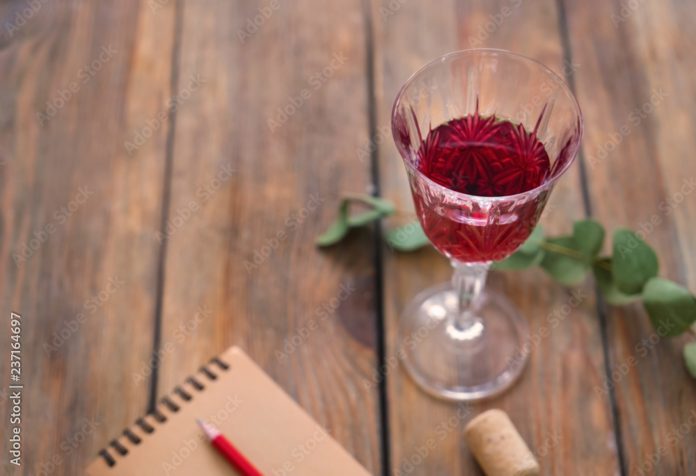Glass of red wine on wooden table