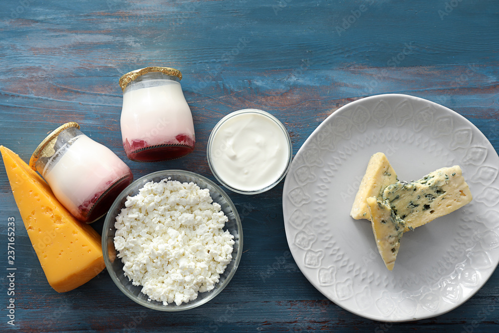 Different milk products on color wooden table
