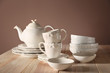 © Pixel-Shot - Set of clean dishware on wooden table