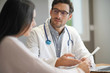 © goodluz - Modern young doctor speaking to patient in office