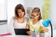 © Syda Productions - education, family and learning concept - mother and daughter with tablet pc computer doing homework together at home