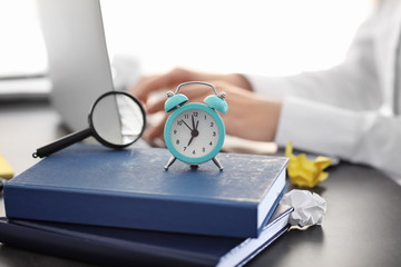 Alarm clock on stack of books