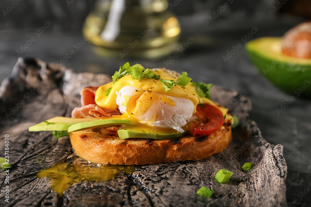 Tasty egg Benedict on plate, closeup