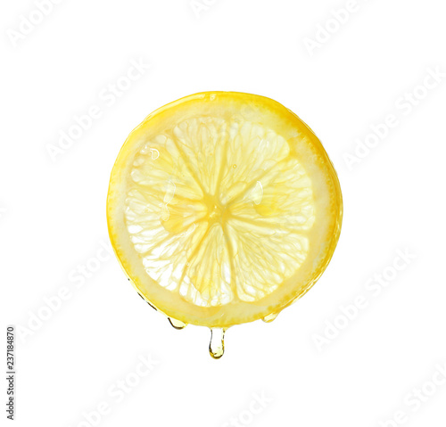 Fotografía Essential oil dripping from lemon slice on white background