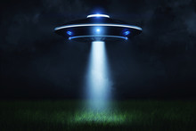 3d Rendering Of A UFO At Night With A Beam Of Light Coming Out Of The Hatch And Lighting A Landing Point In The Green Grass.