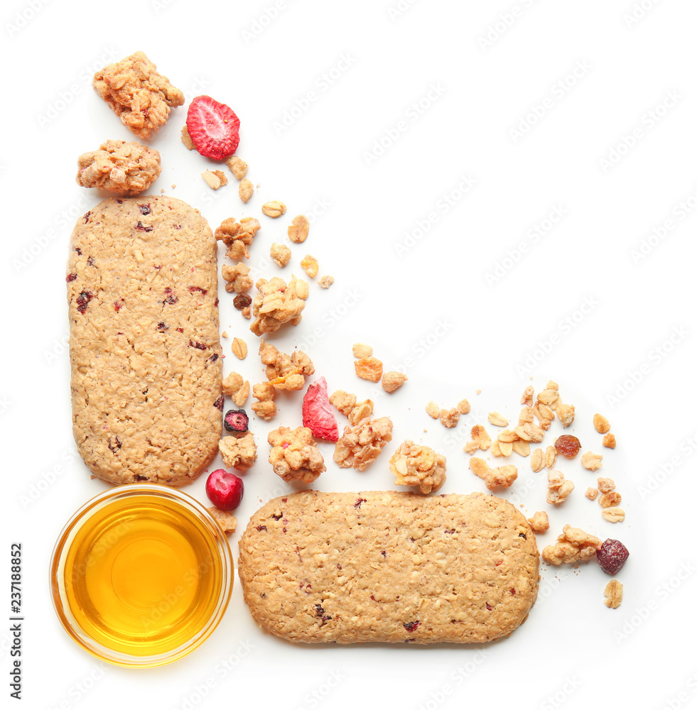 Composition with granola, cookies and sweet honey on white background