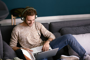 Canvas Print - Young man listening to music at home