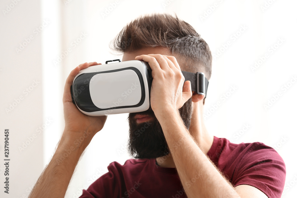 Man wearing virtual reality glasses at home