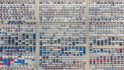 Cars export terminal in export and import business and logistics. Shipping cargo to harbor. Water transport International. Aerial view and top view.