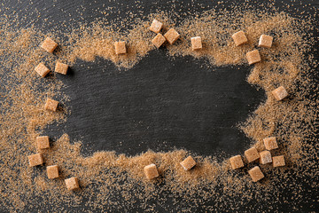 Wall Mural - Frame made of brown sugar on dark table