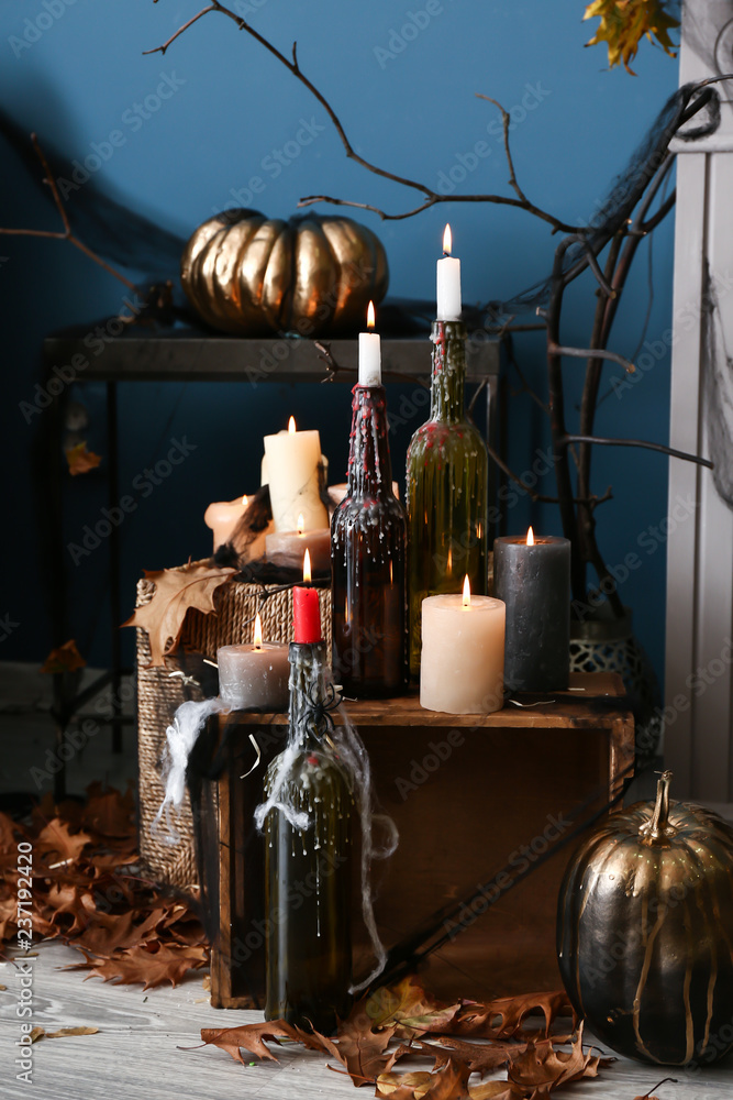 Burning candles as decor for Halloween party in room