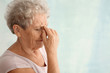 © Pixel-Shot - Senior woman suffering from headache on light background