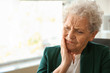 Senior woman suffering from toothache indoors