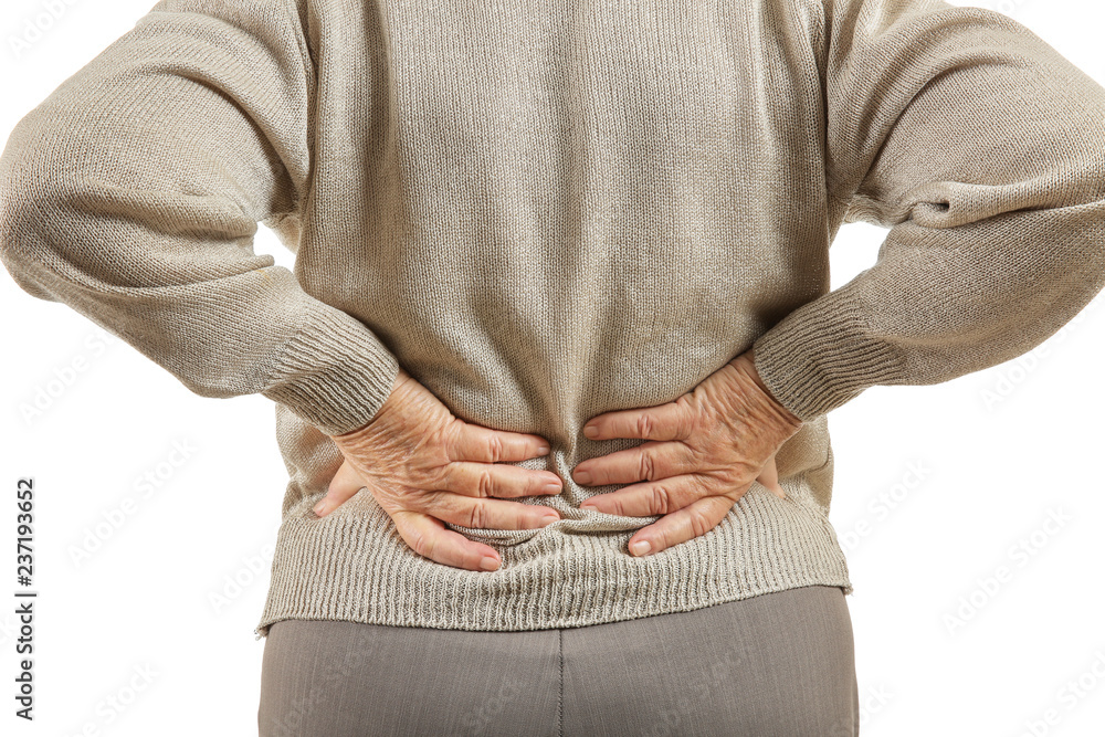 Senior woman suffering from back pain on white background