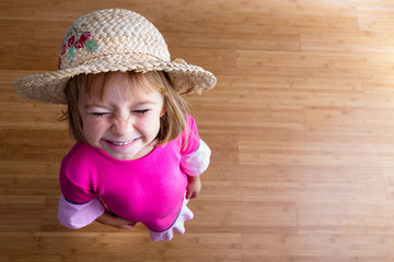 young girl in straw hat from above