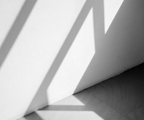 Abstract background of a white wall with shadows from the window. - monochrome