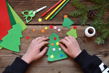 Making Of Handmade Christmas Tree From Felt With Your Own Hands. Children's DIY Concept. Making Xmas Toys Decoration Or Greeting Card. Step 3. Decorate The Toy.